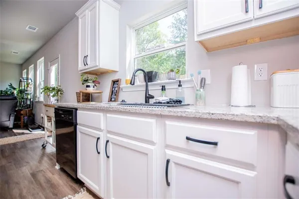 a kitchen with appliances cabinets and a table