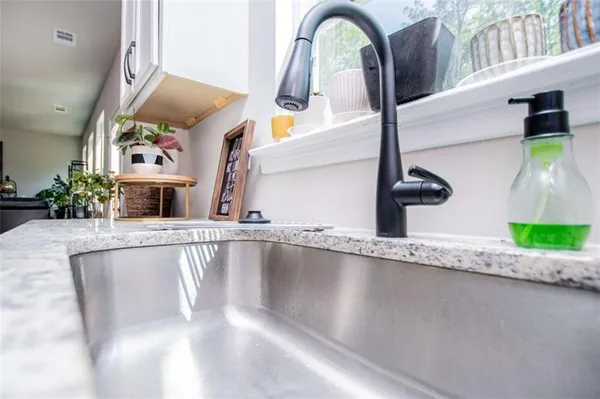 a kitchen with stainless steel appliances granite countertop a sink stove and cabinets