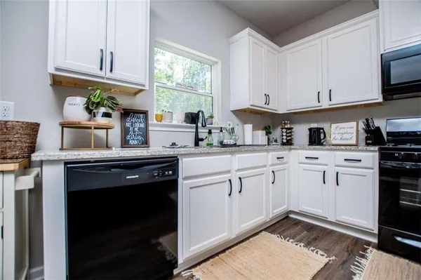 a kitchen with wooden floors and white appliances