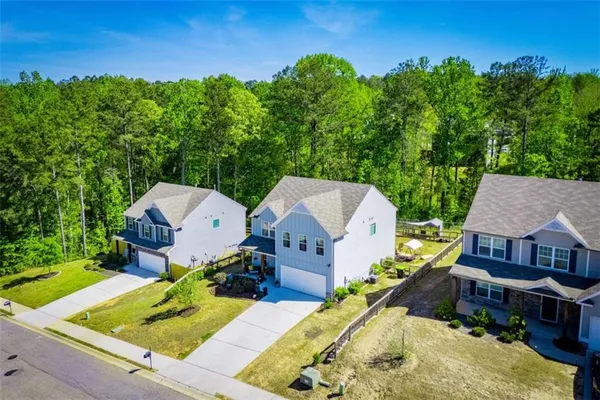 an aerial view of a house with swimming pool garden and patio