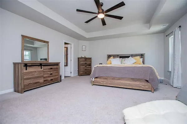 a bedroom with a bed and dresser