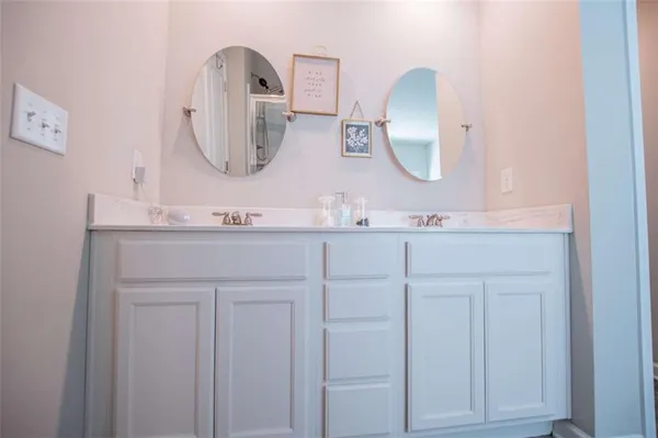 a bathroom with a double vanity sink and mirror