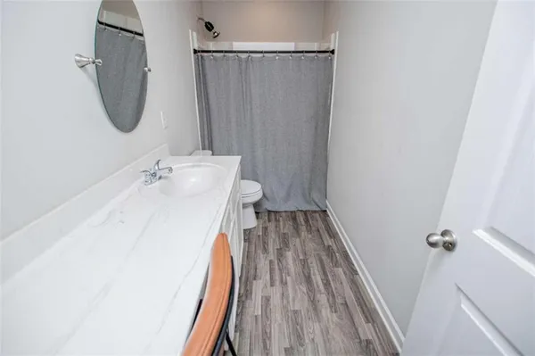 a bathroom with a toilet a sink and a mirror