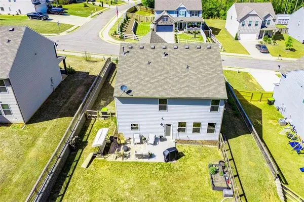 an aerial view of a house with a yard basket ball court and outdoor seating