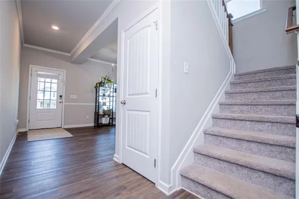 a view of entryway with wooden floor and stairs