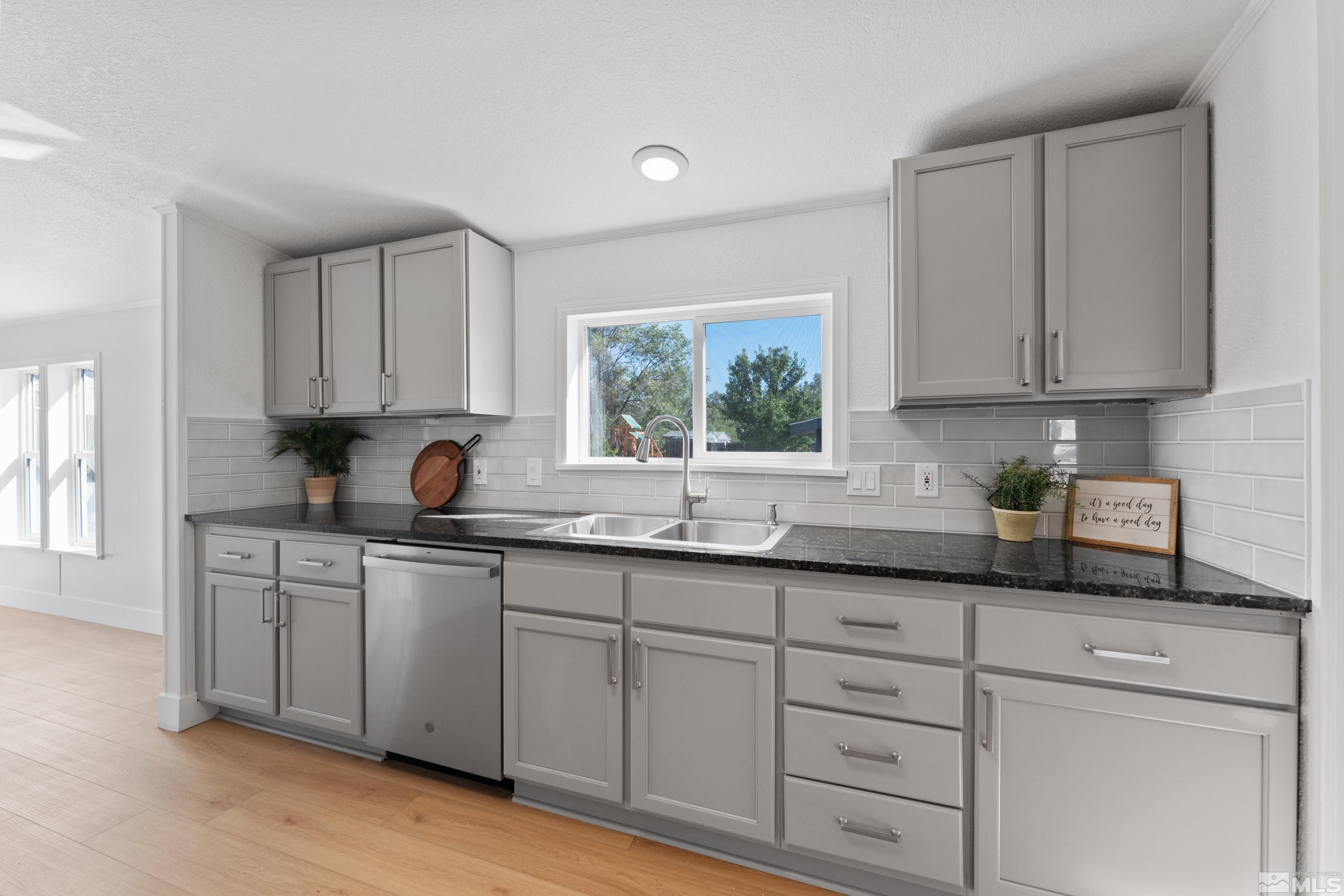 7640 Lytton Road Reno, NV 89506 - Photo 12 of 40 a kitchen with white cabinets and sink