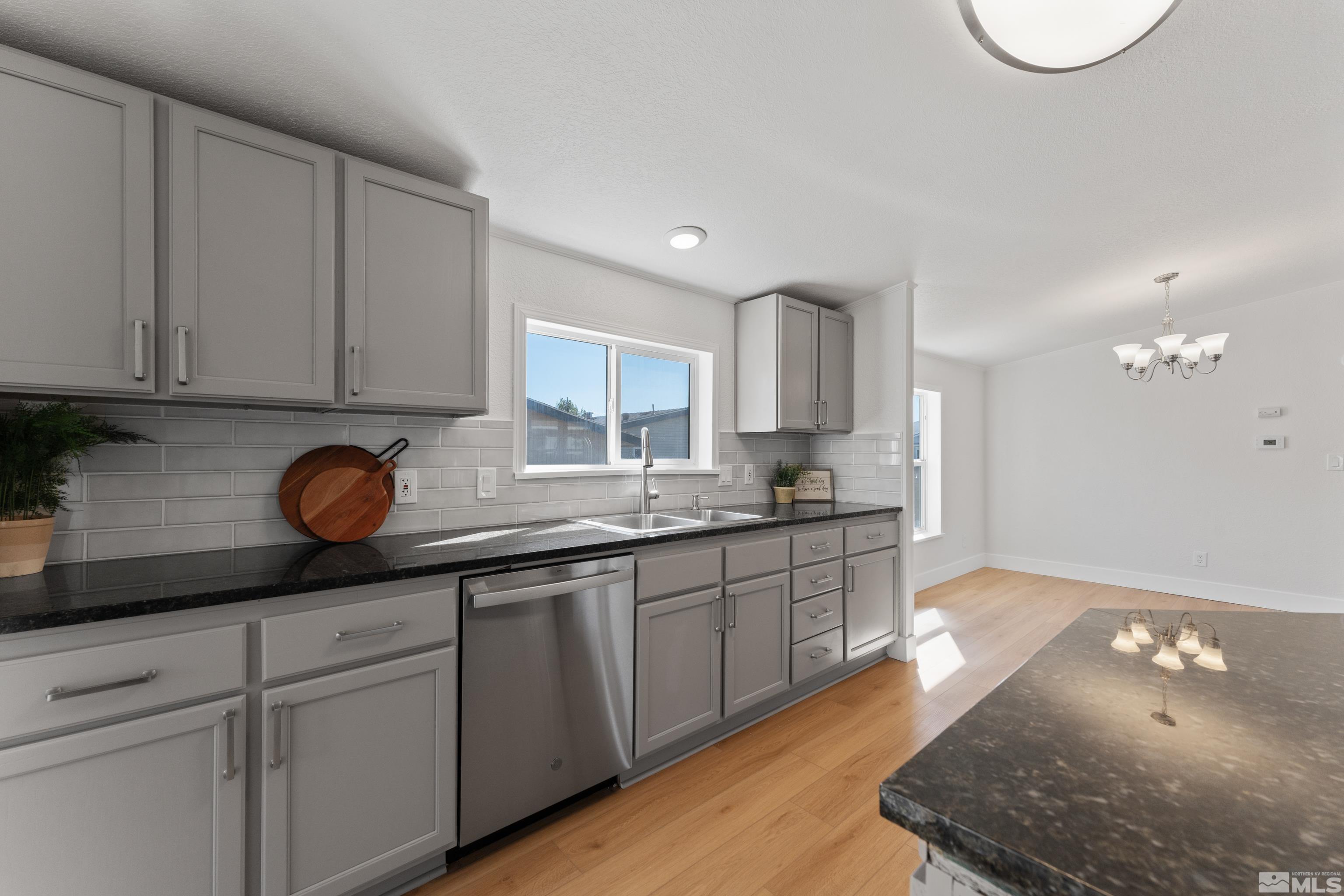 7640 Lytton Road Reno, NV 89506 - Photo 14 of 40 a kitchen with granite countertop a sink a stove cabinets and a granite counter top