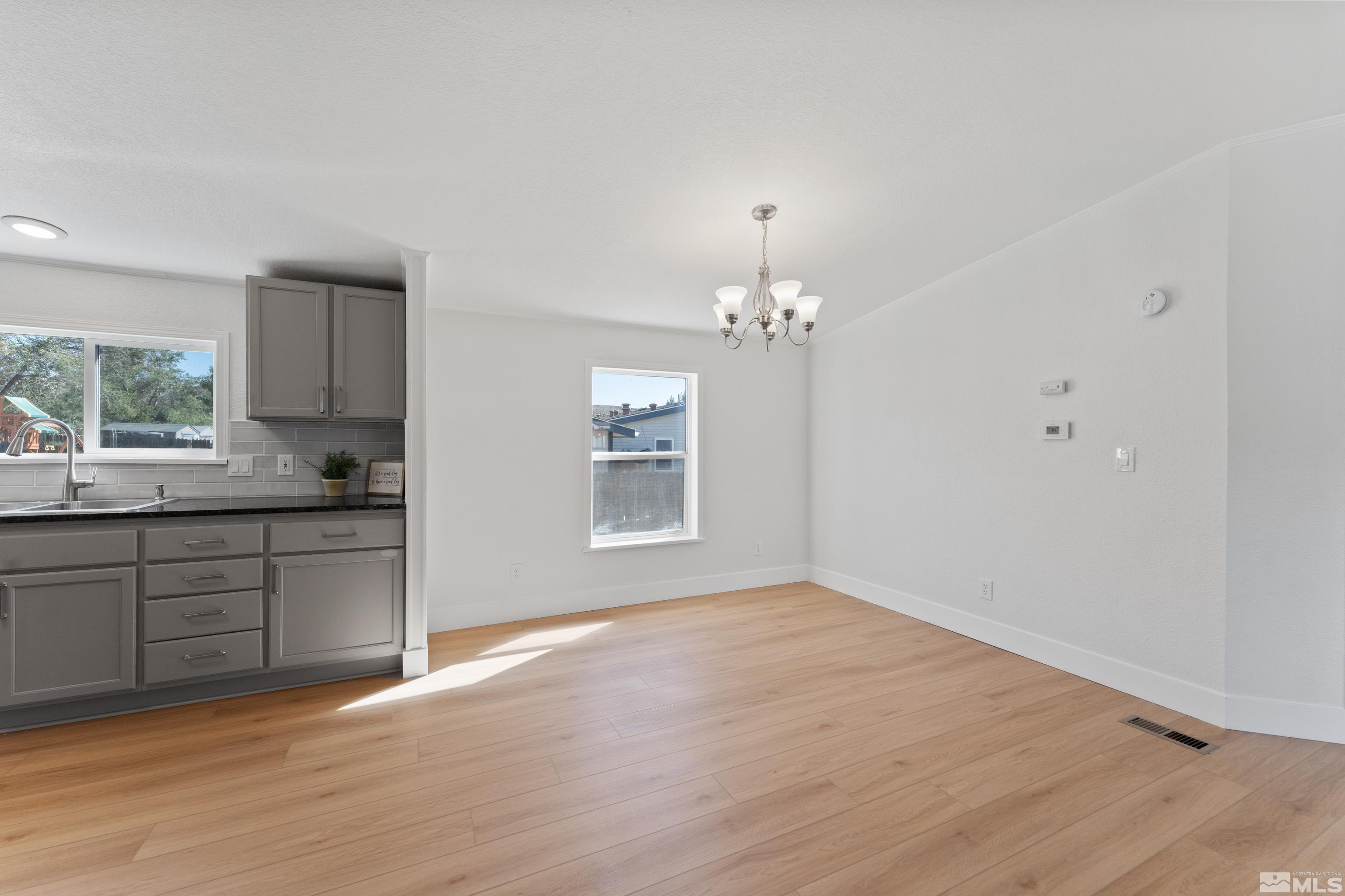 7640 Lytton Road Reno, NV 89506 - Photo 15 of 40 a view of a kitchen with a sink cabinets and wooden floor