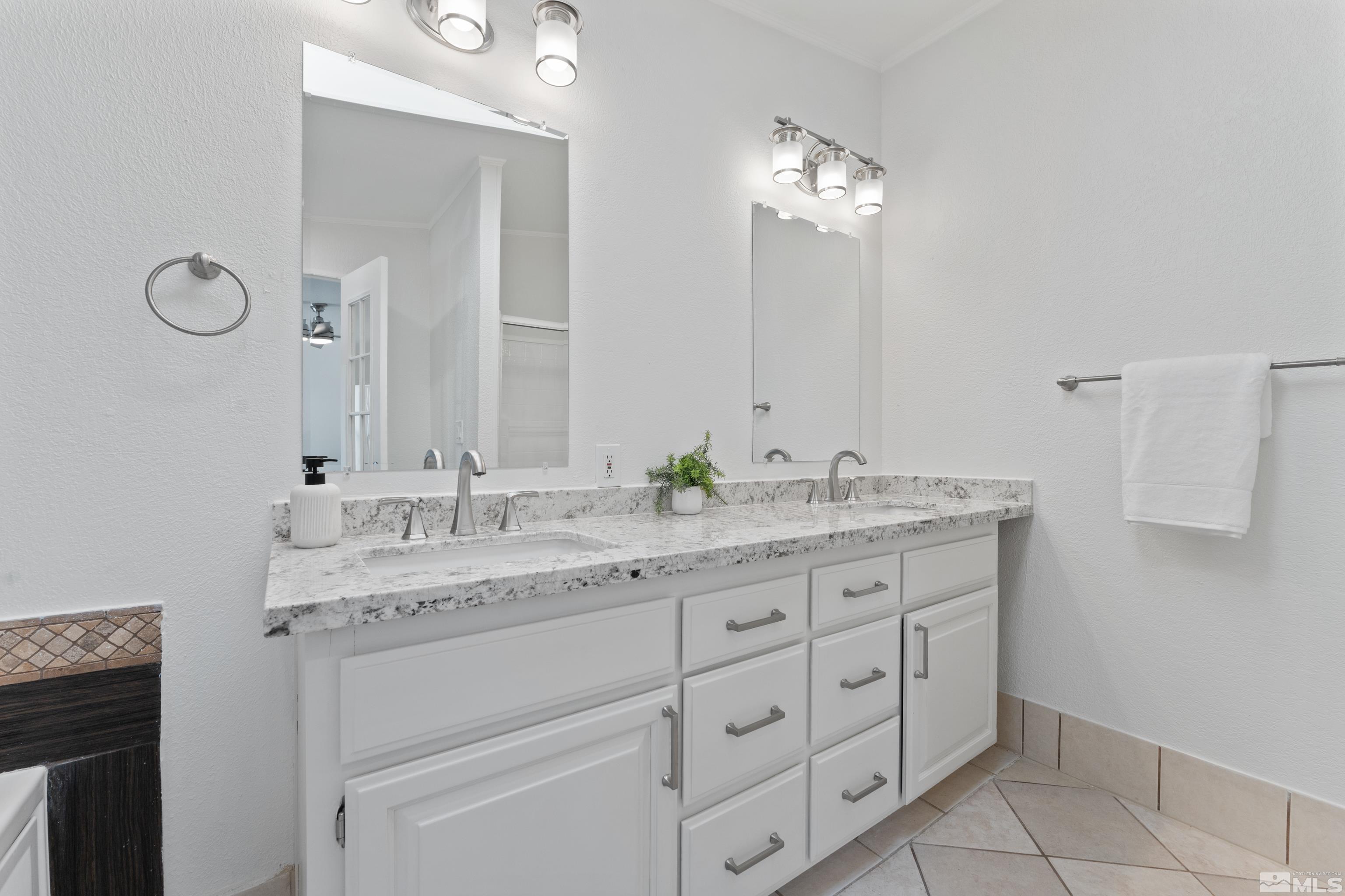 7640 Lytton Road Reno, NV 89506 - Photo 20 of 40 a bathroom with a granite countertop sink double and mirror