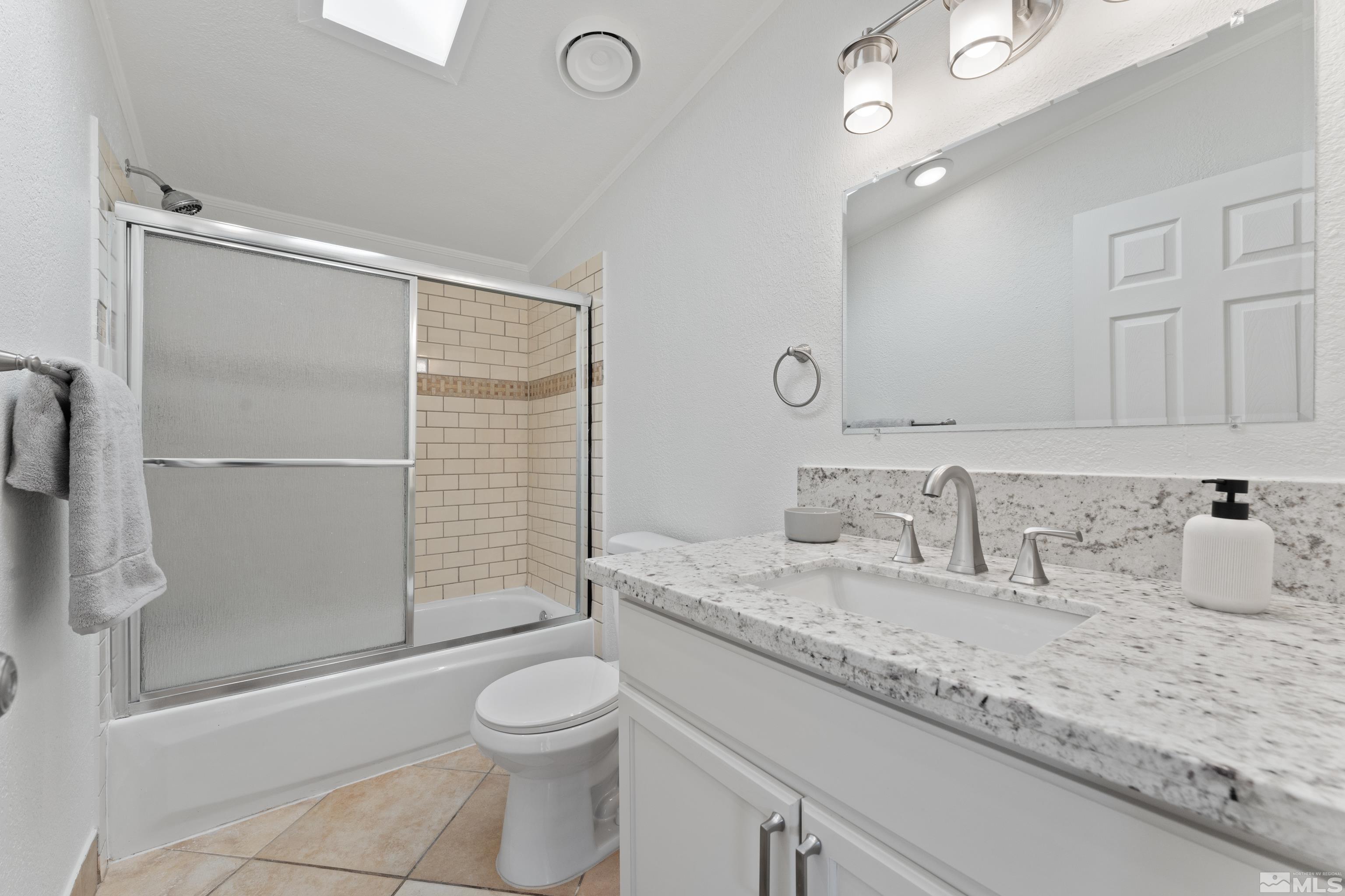 7640 Lytton Road Reno, NV 89506 - Photo 29 of 40 a bathroom with a granite countertop sink toilet and shower