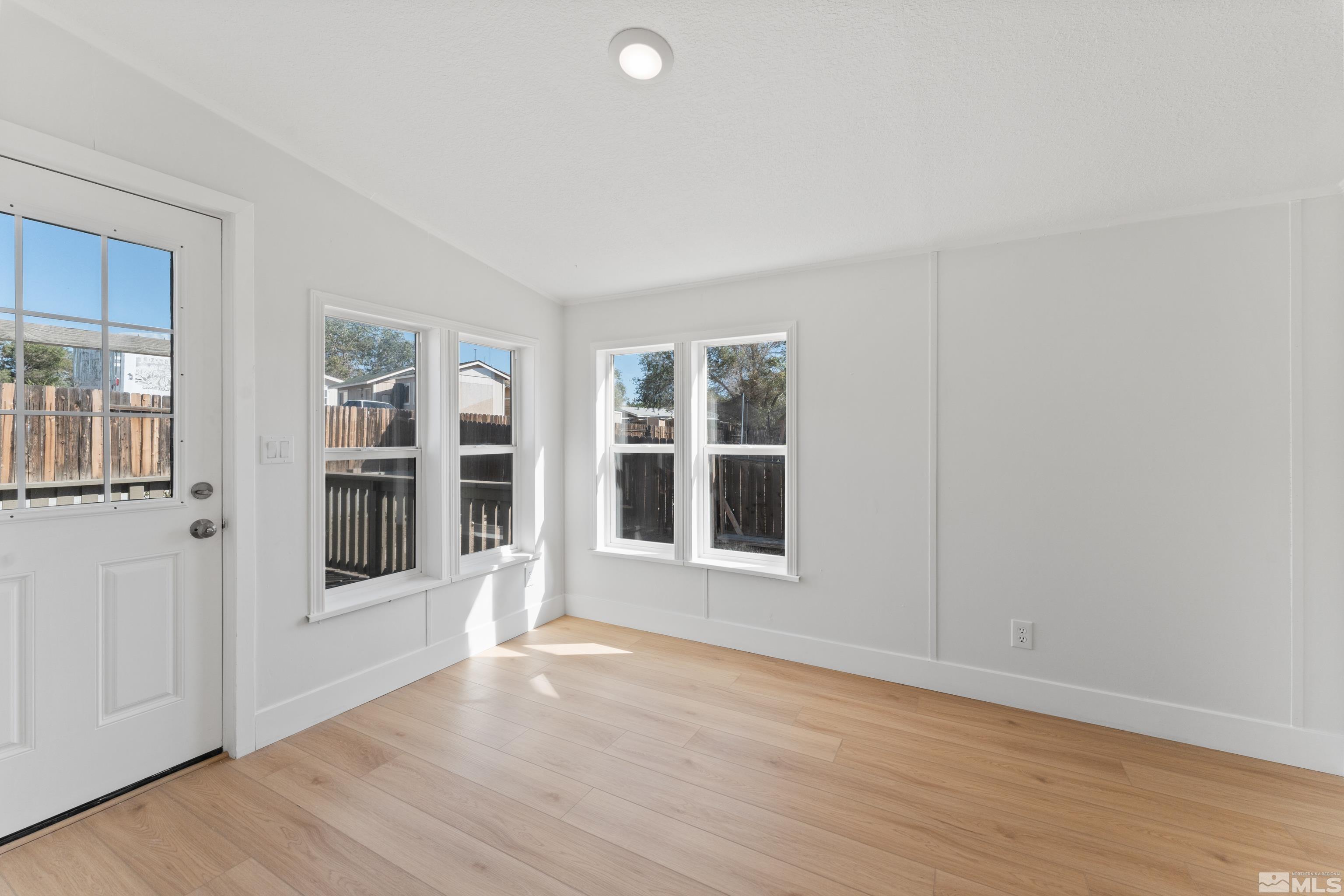 7640 Lytton Road Reno, NV 89506 - Photo 32 of 40 a view of an empty room with wooden floor and windows