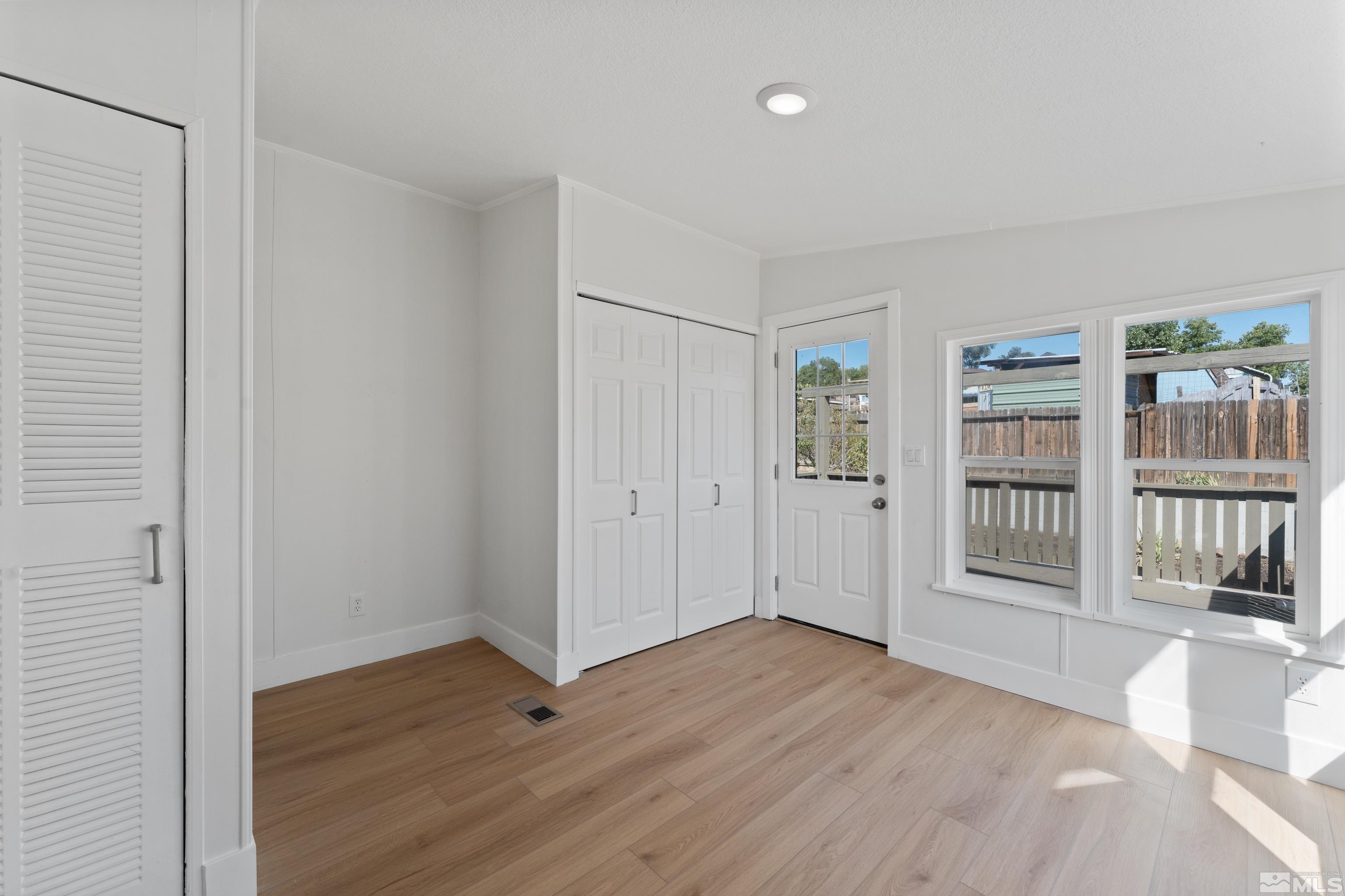 7640 Lytton Road Reno, NV 89506 - Photo 33 of 40 a view of an empty room with wooden floor and a window