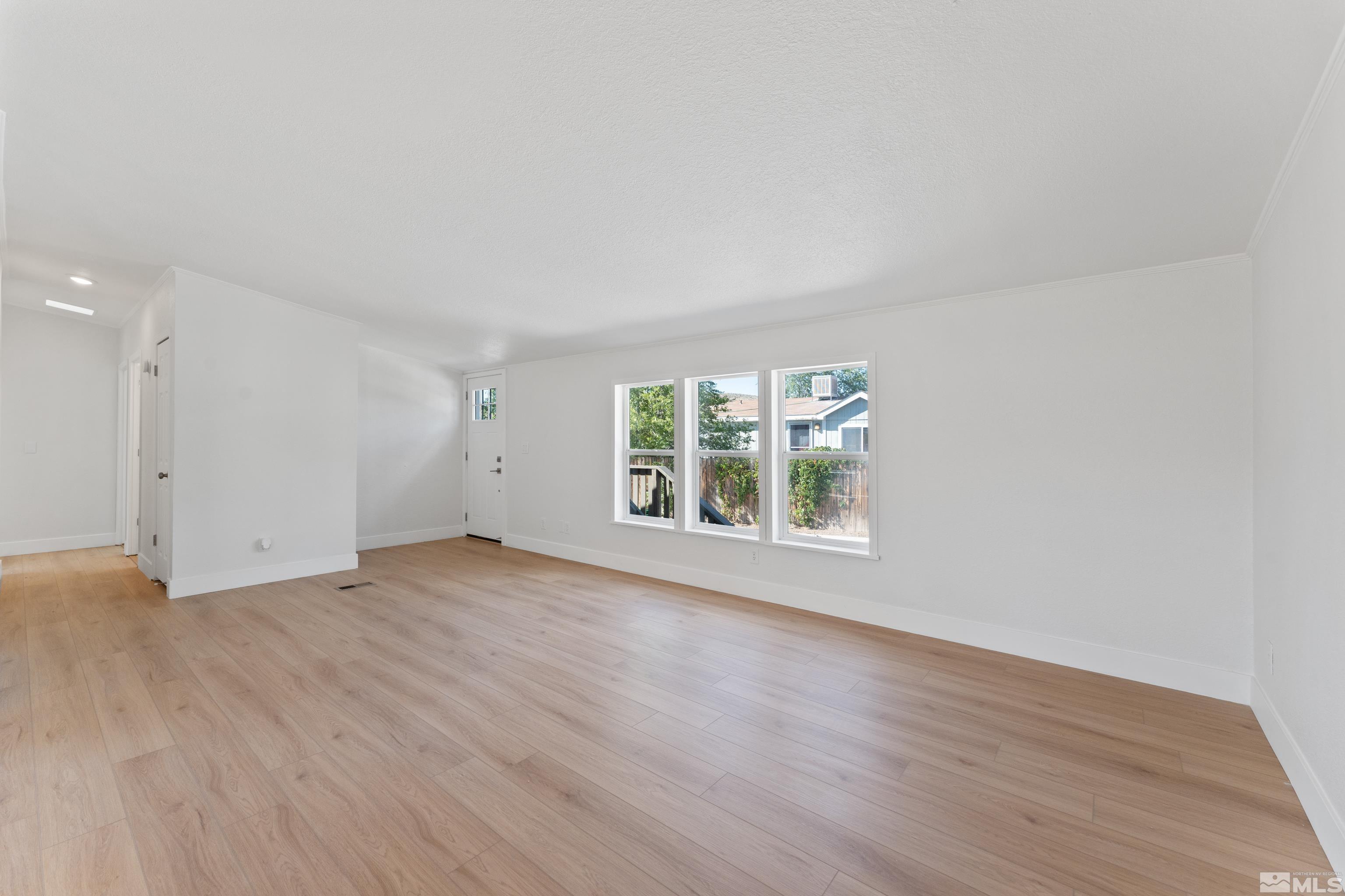 7640 Lytton Road Reno, NV 89506 - Photo 7 of 40 an empty room with wooden floor and windows