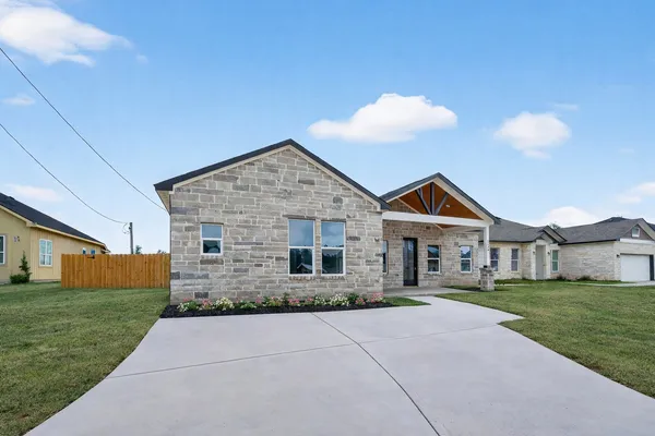 a front view of house with yard and green space