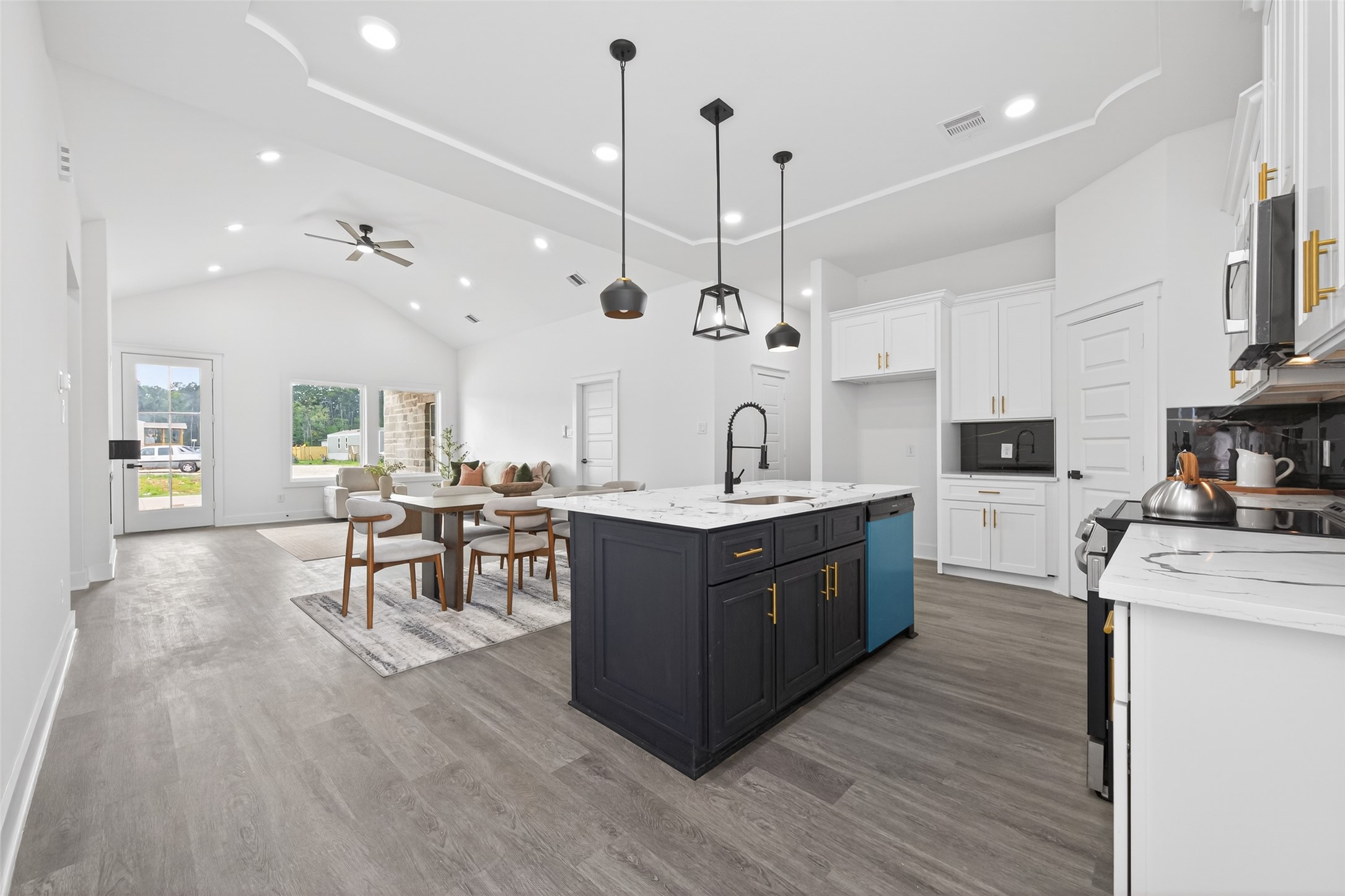 1129 Longleaf Pne Street Huffman, TX 77336 - Photo 12 of 35 a large kitchen with stainless steel appliances a large center island attached withe living room