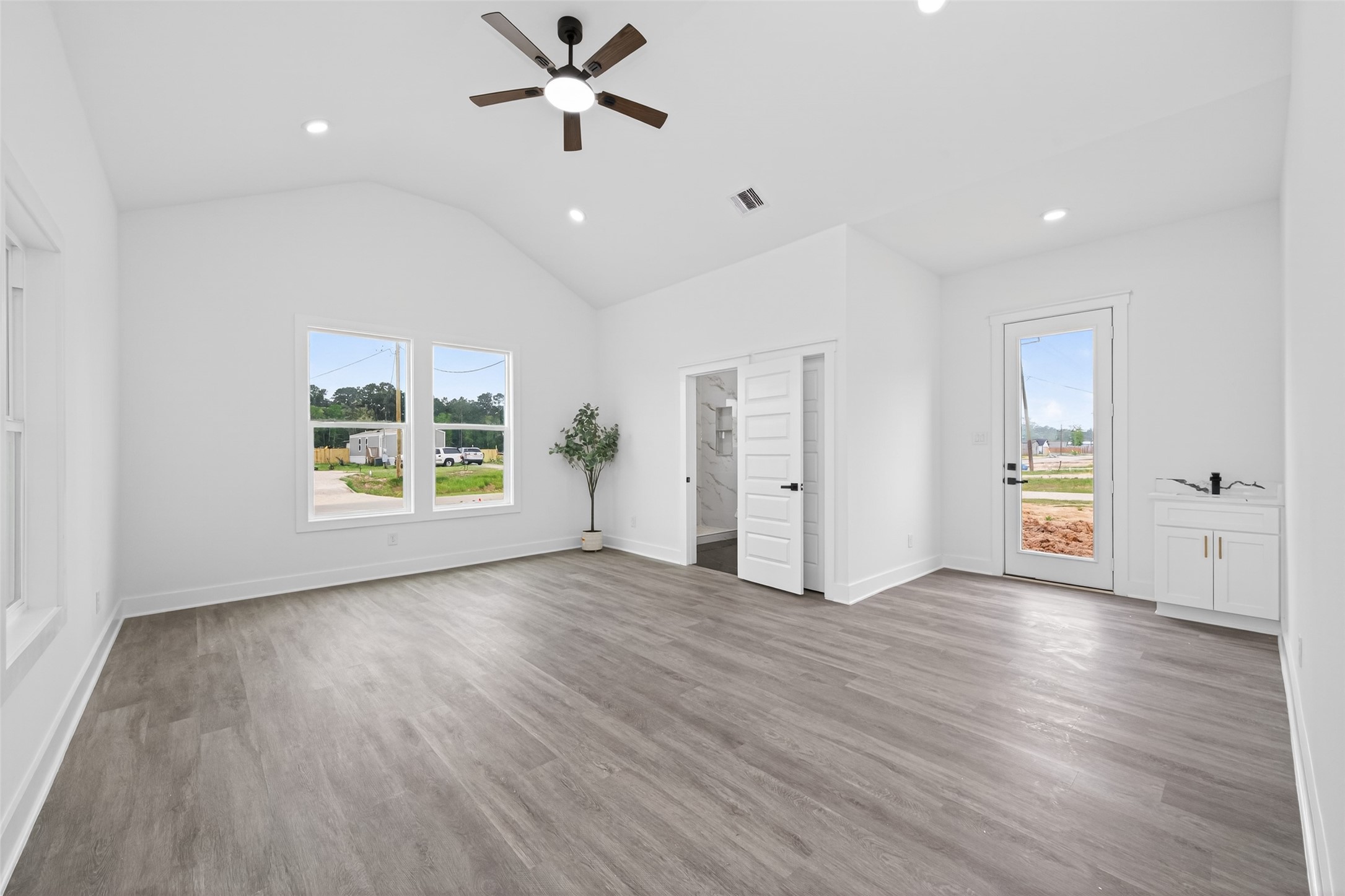 1129 Longleaf Pne Street Huffman, TX 77336 - Photo 22 of 35 a view of an empty room with a window and wooden floor