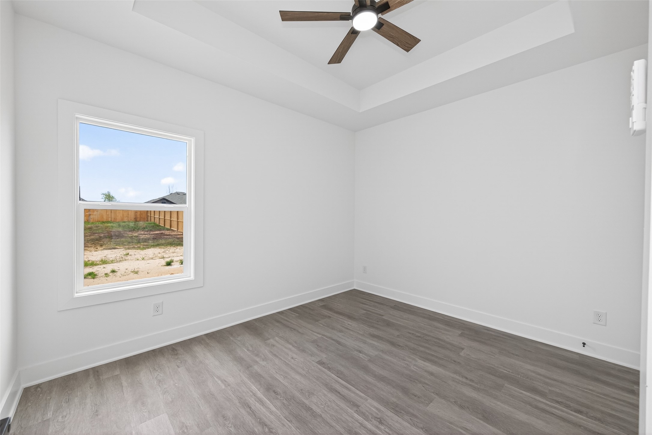 1129 Longleaf Pne Street Huffman, TX 77336 - Photo 26 of 35 wooden floor in an empty room with a window
