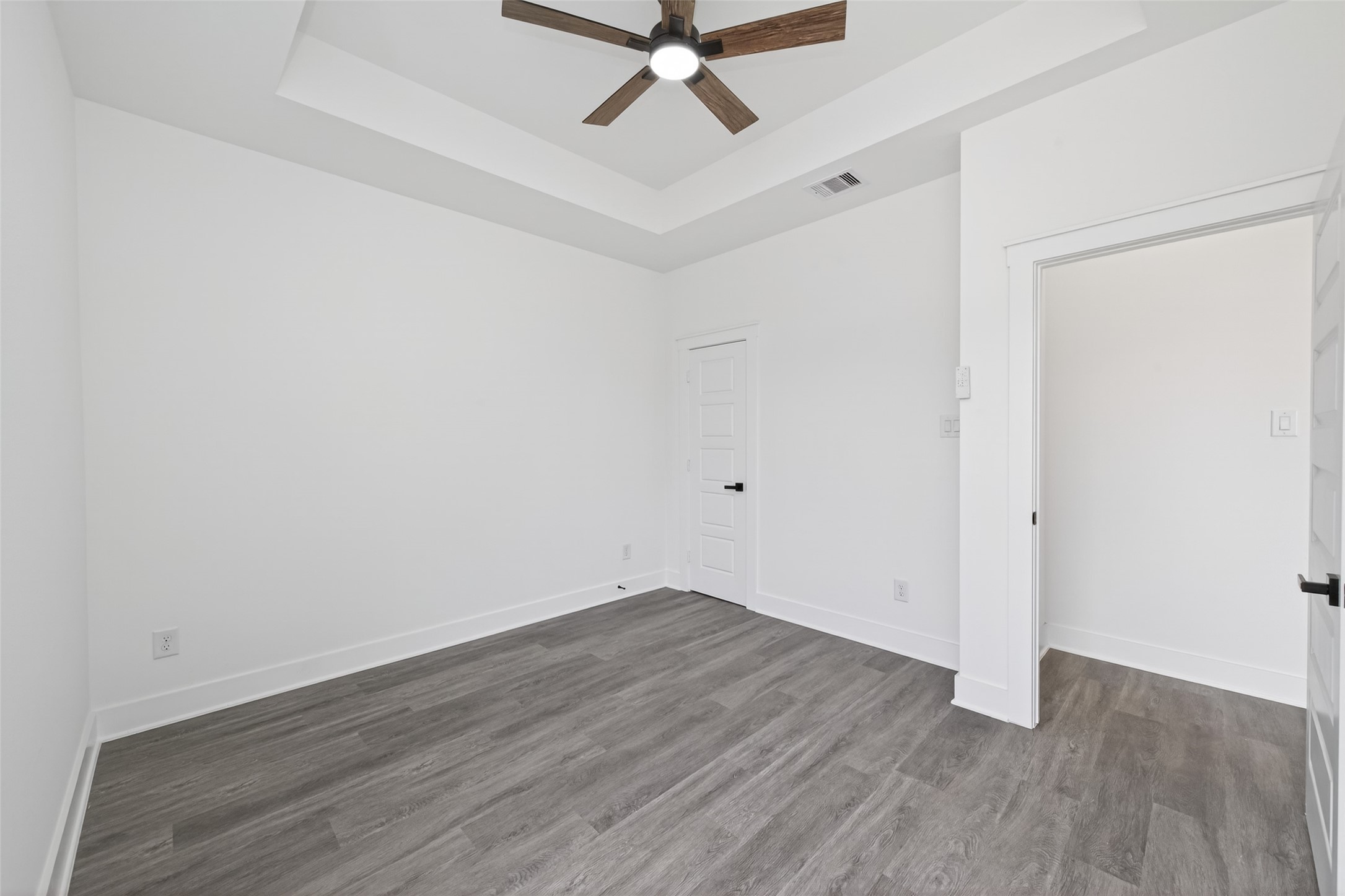 1129 Longleaf Pne Street Huffman, TX 77336 - Photo 29 of 35 a view of a room with wooden floor and a ceiling fan