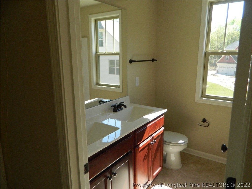22 Raintree Lane Spring Lake, NC 28390 - Photo 14 of 33 a bathroom with a sink toilet and window