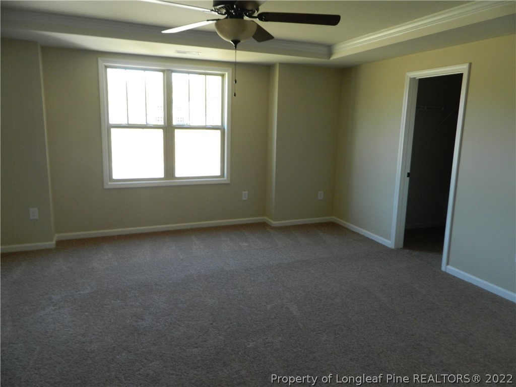 22 Raintree Lane Spring Lake, NC 28390 - Photo 23 of 33 an empty room with a ceiling fan and windows