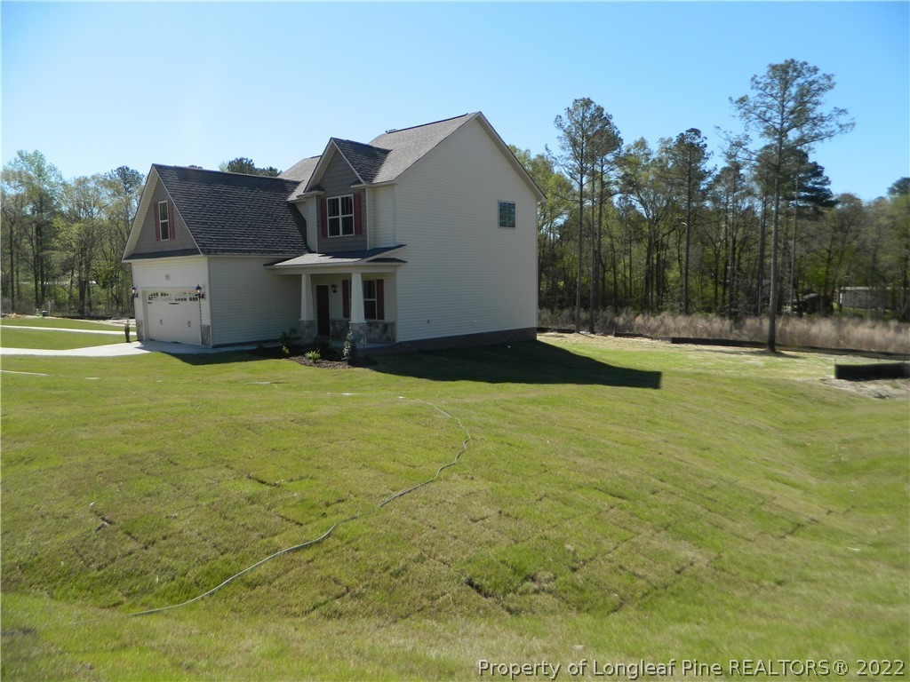 22 Raintree Lane Spring Lake, NC 28390 - Photo 32 of 33 a backyard of a house with table and chairs