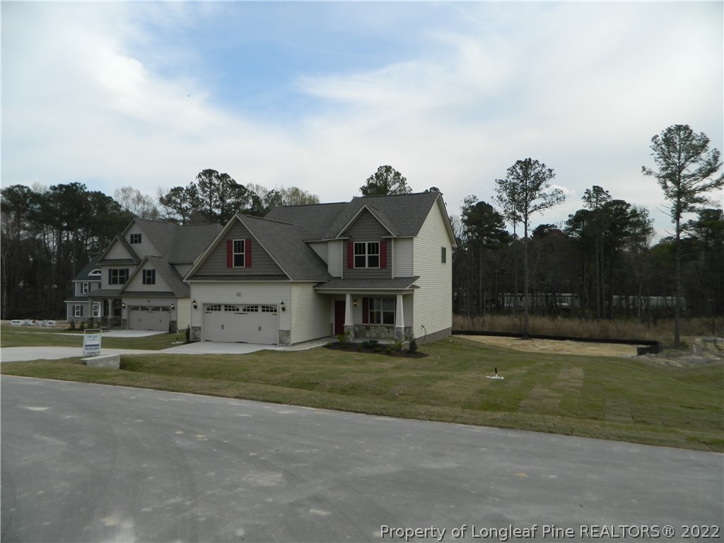 22 Raintree Lane Spring Lake, NC 28390 - Photo 4 of 33 a front view of a house with a garden