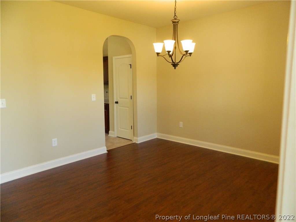 22 Raintree Lane Spring Lake, NC 28390 - Photo 8 of 33 an empty room with wooden floor and windows