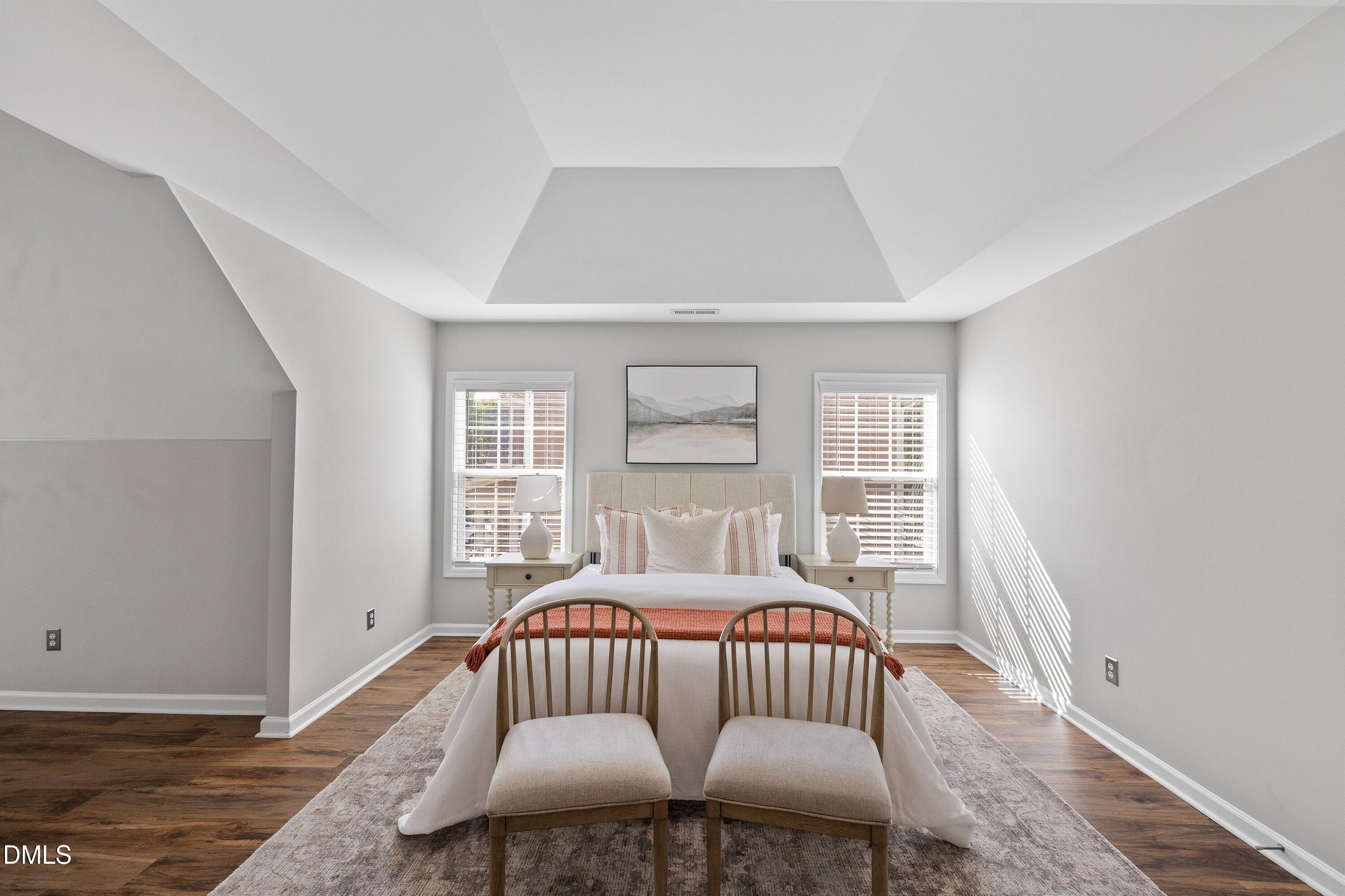 3717 Windmeade Road Wake Forest, NC 27587 - Photo 28 of 51 a bedroom with a bed and wooden floor