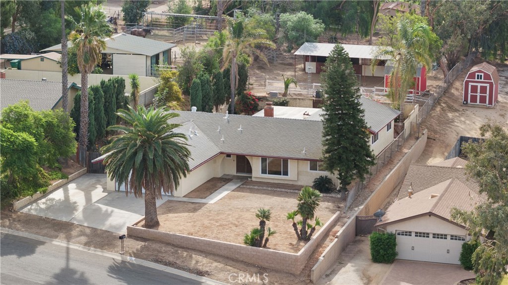 an aerial view of residential houses with palm trees
