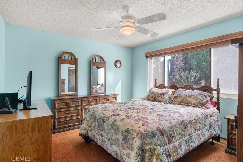 3518 Chestnut Drive Norco, CA 92860 - Photo 11 of 38 a bedroom with a bed a chandelier and a large window