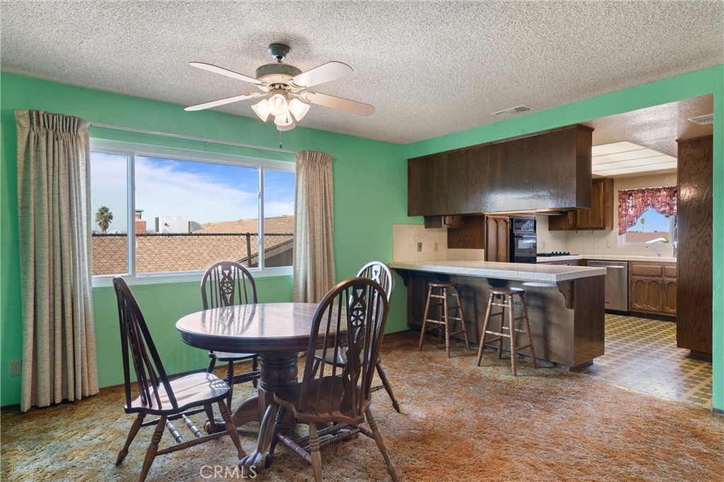 3518 Chestnut Drive Norco, CA 92860 - Photo 6 of 38 a dining room with furniture a window and a chandelier