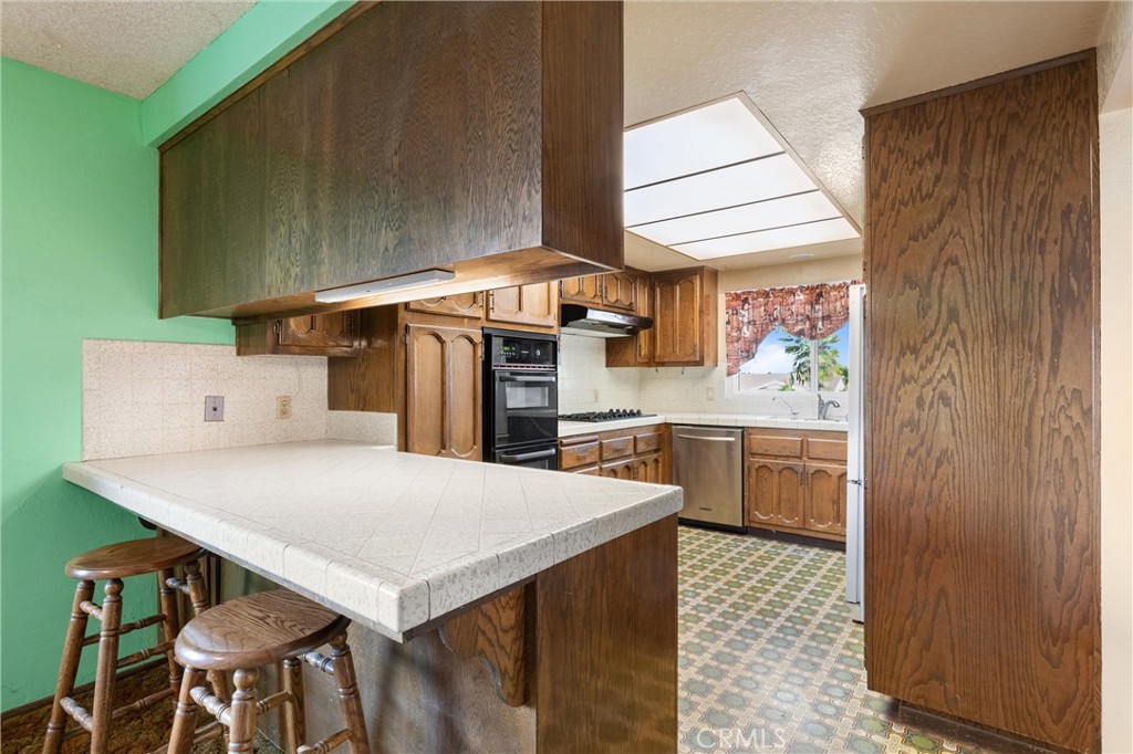 3518 Chestnut Drive Norco, CA 92860 - Photo 7 of 38 a kitchen with stainless steel appliances cabinets and wooden floor