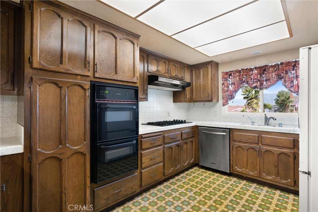 3518 Chestnut Drive Norco, CA 92860 - Photo 9 of 38 a kitchen with stainless steel appliances granite countertop a refrigerator and a stove top oven