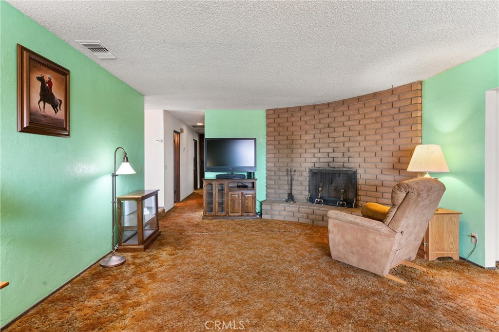 3518 Chestnut Drive Norco, CA 92860 - Photo 10 of 38 a living room with furniture and a fireplace