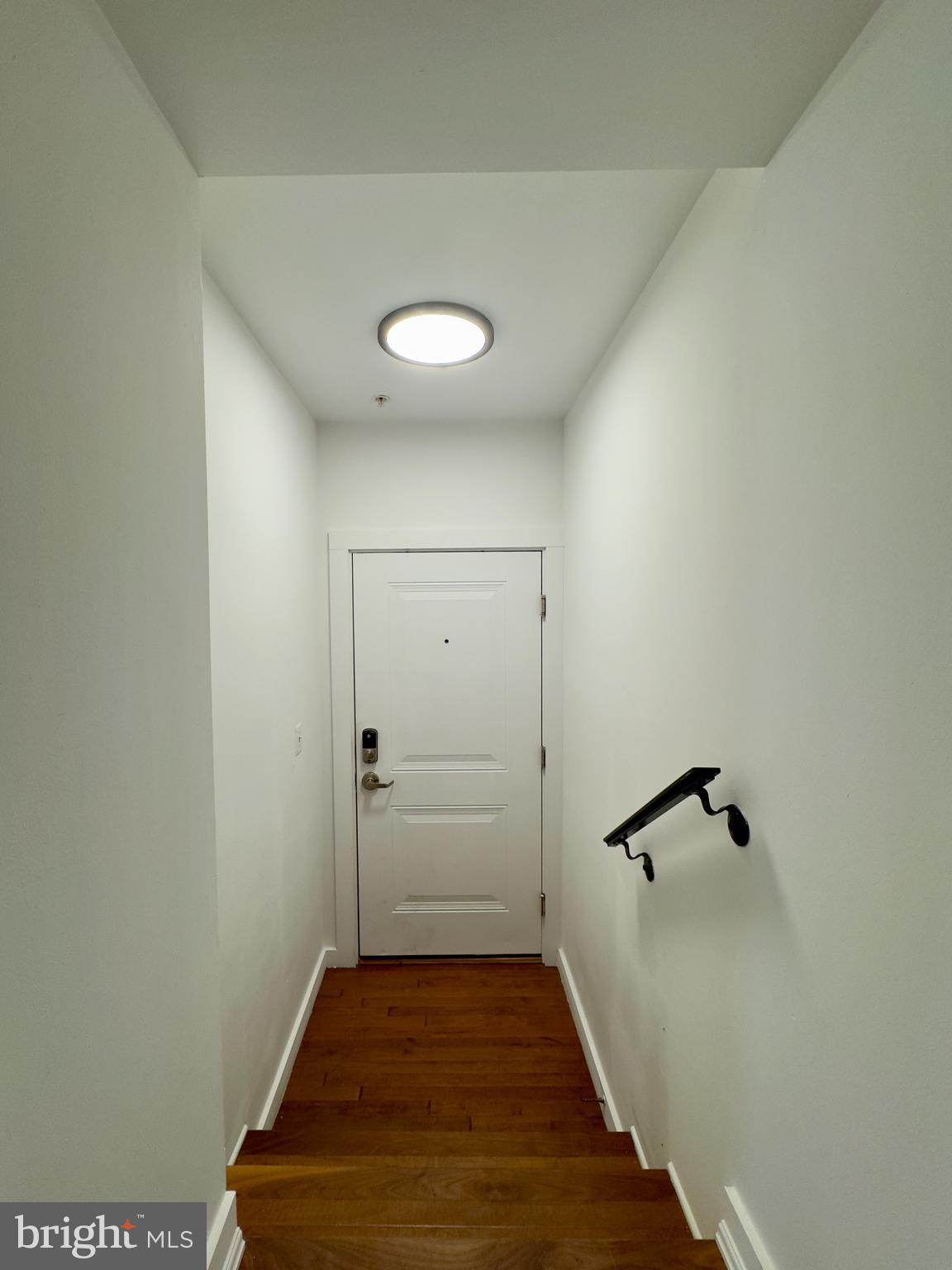 613 Portland Street, Unit 11 Baltimore, MD 21230 - Photo 3 of 9 a view of a hallway with wooden floor