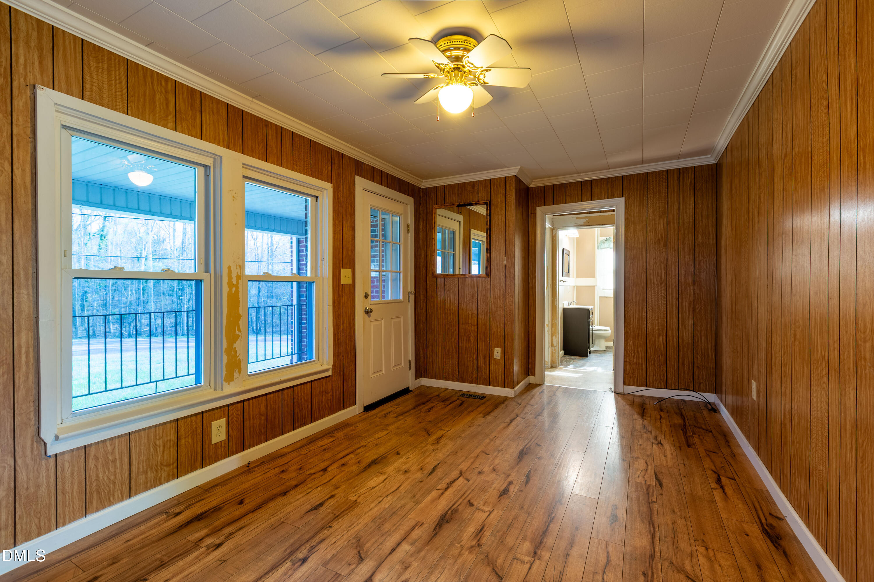 4295 Virgilina Road Roxboro, NC 27574 - Photo 5 of 46 a view of an empty room with window and wooden floor
