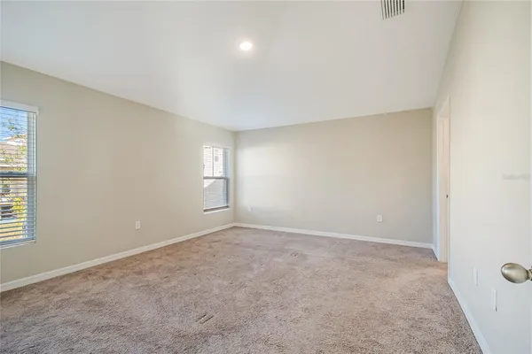 an empty room with windows and closet