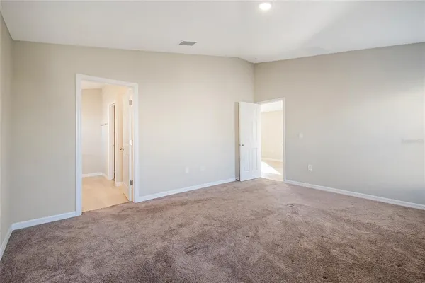 a view of an empty room and closet area