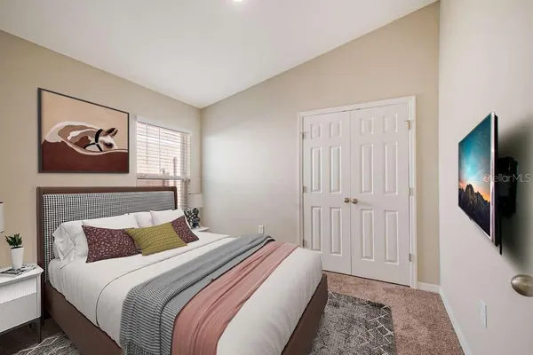 a bedroom with a bed and a flat screen tv