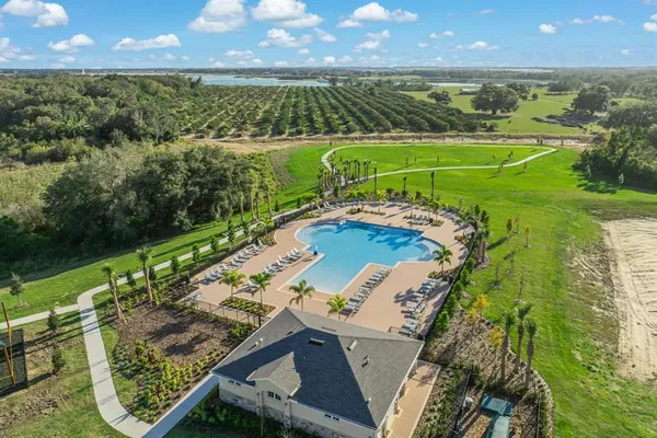 an aerial view of a house with a garden and lake view