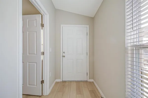 a view of a hallway with wooden floor