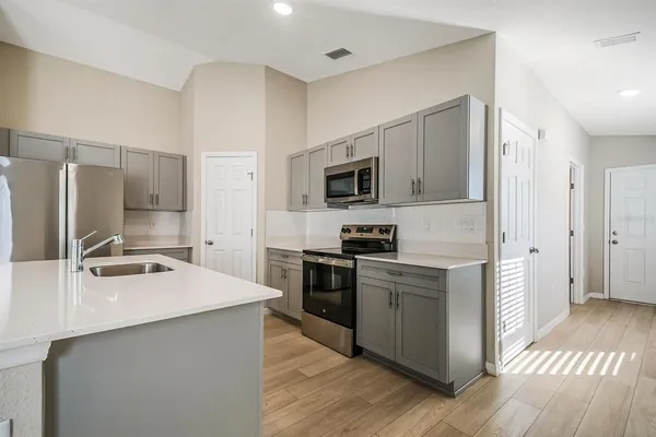 a kitchen with a sink appliances and cabinets