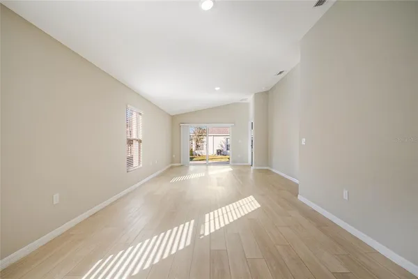 a view of a room with wooden floor and window