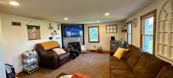 a living room with furniture a flat screen tv and a fireplace