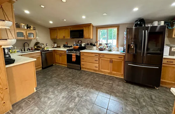 a kitchen with lots of counter top space and stainless steel appliances