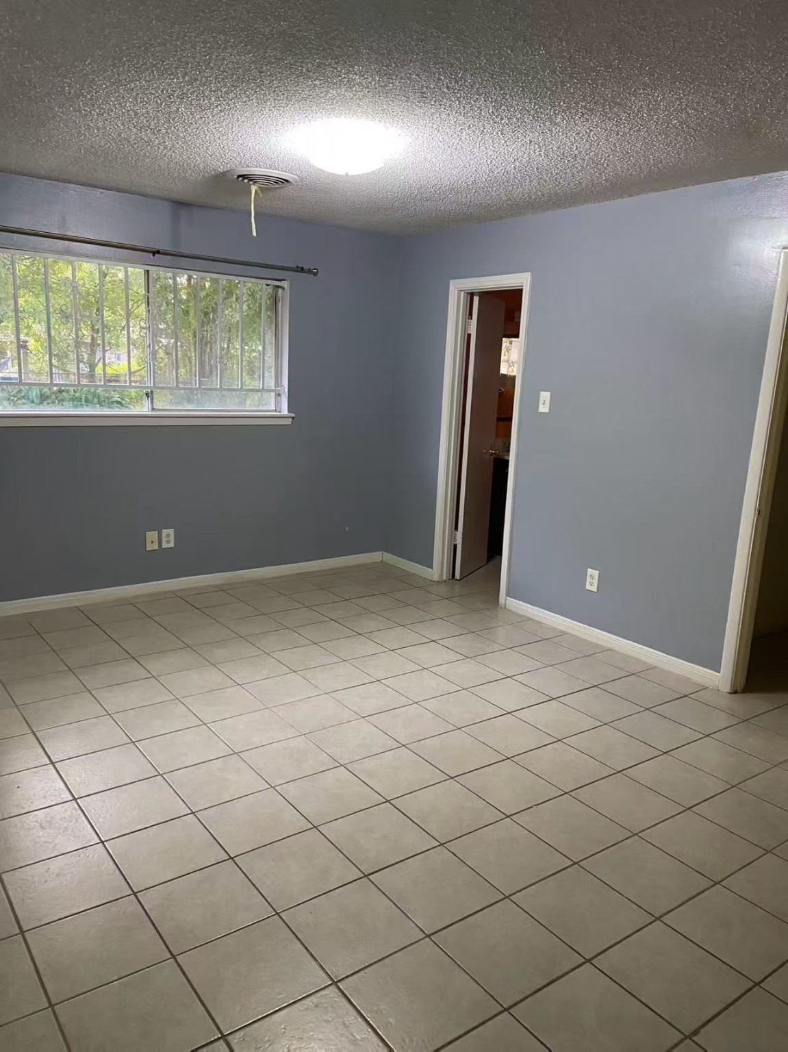 8911 Mobud Drive Houston, TX 77036 - Photo 2 of 8 a view of an empty room and window