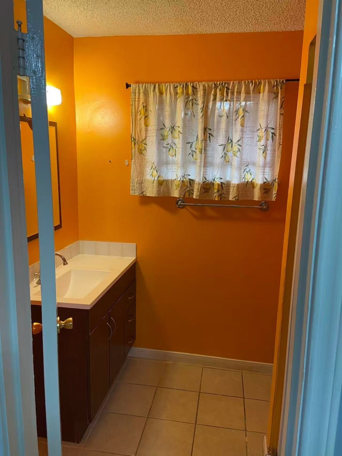 8911 Mobud Drive Houston, TX 77036 - Photo 5 of 8 a bathroom with a granite countertop sink and a mirror