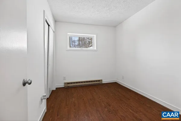 a view of a kitchen with furniture and wooden floor