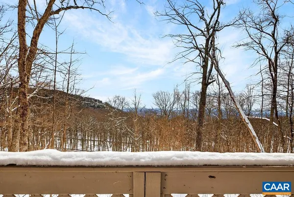 a view of a room with wooden floor and a window