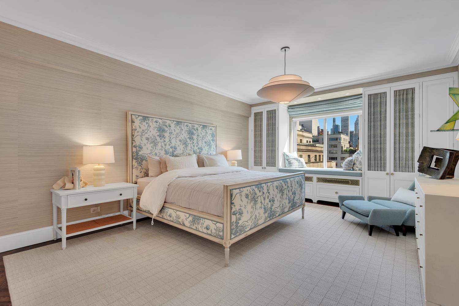 3 East 71st Street, Unit 10/11B Manhattan, NY 10021 - Photo 9 of 17 a bedroom with a bed couch chandelier and window